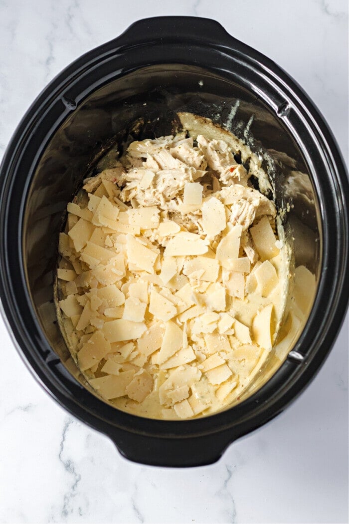 shredded chicken in slow cooker with parmesan cheese