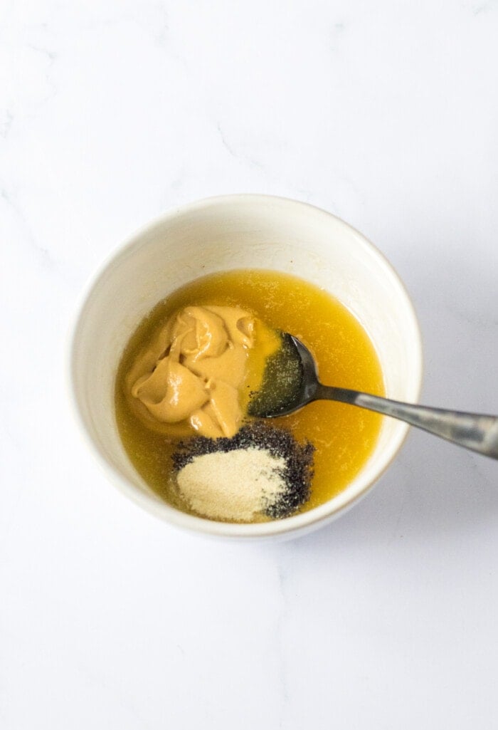 Adding the mustard to the sauce.