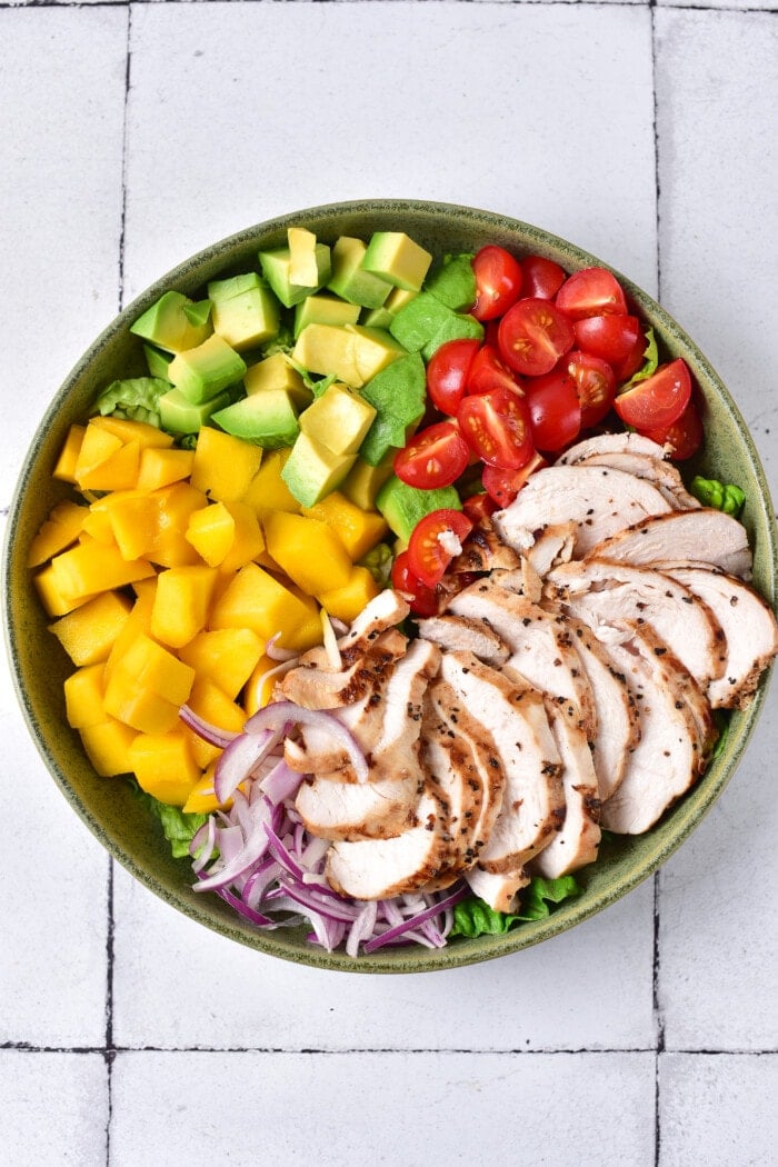 This Mango Chicken Salad is the perfect combination of sweet, savory, creamy, and crunchy in every bite. Adding the meat to the Mango Chicken Salad.