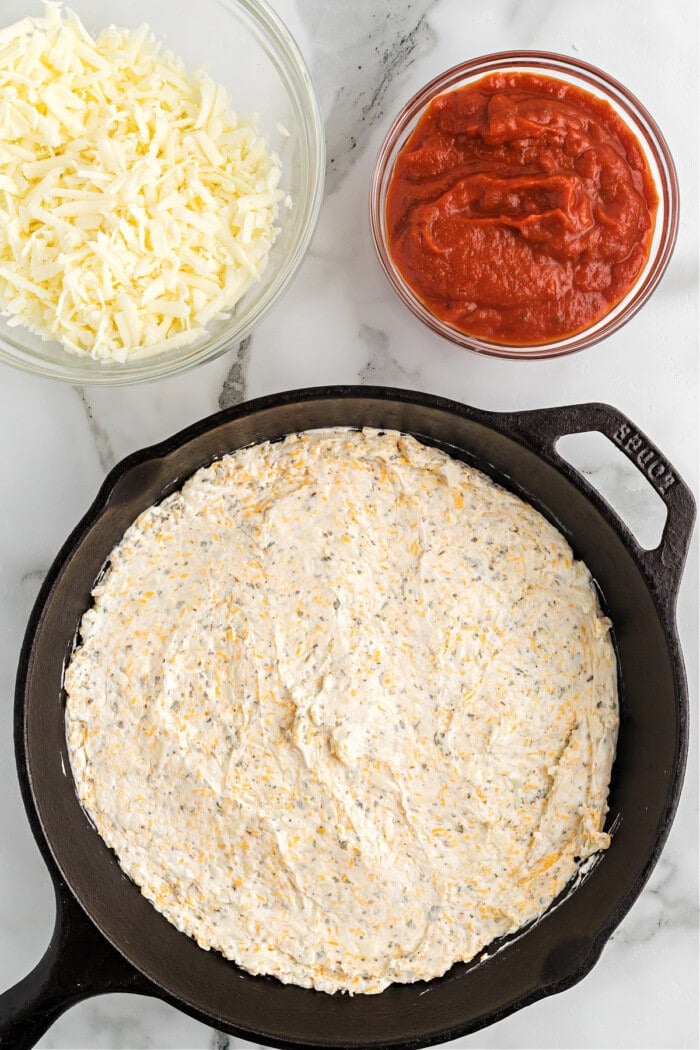 cream cheese and cheese mixture in cast iron skillet