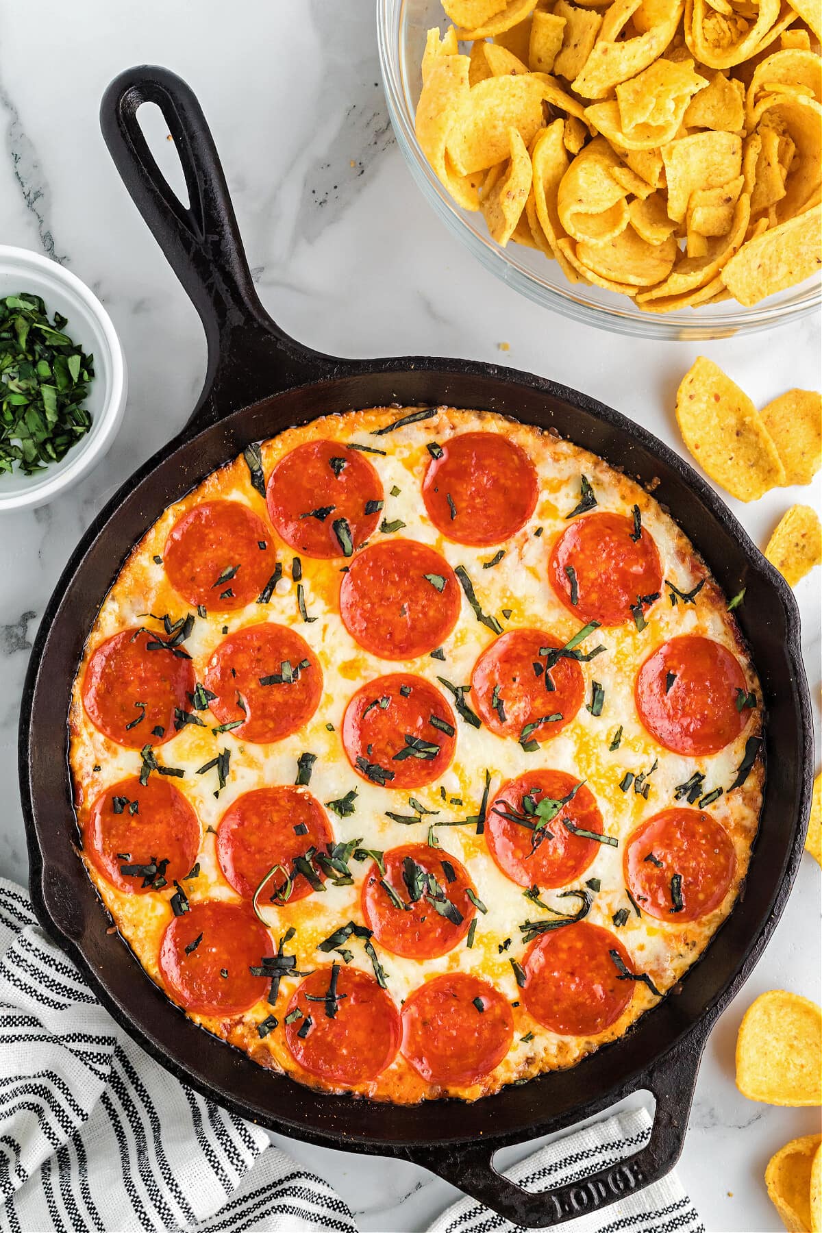 pizza dip in cast iron skillet with corn chips