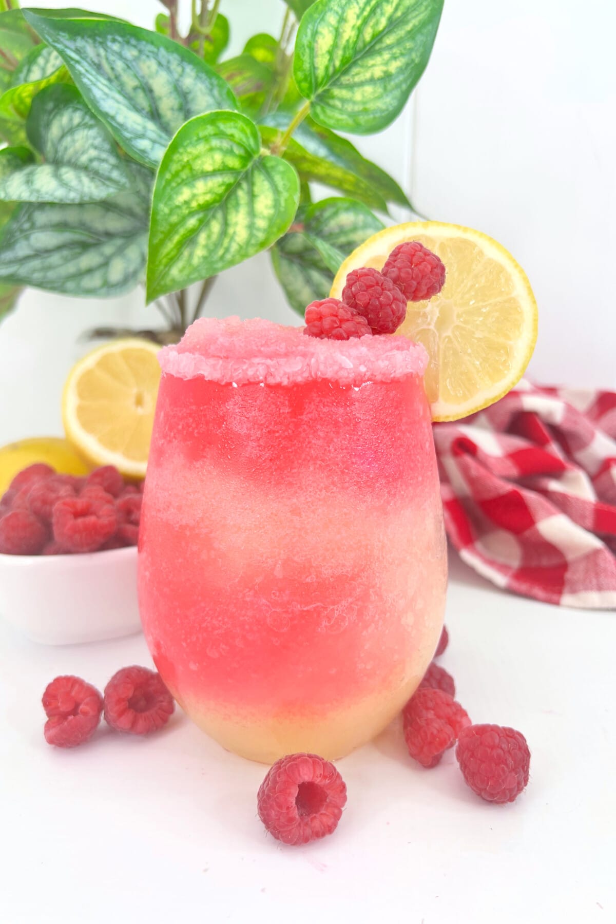 Raspberry Lemonade Cocktail with fresh raspberries on the table.