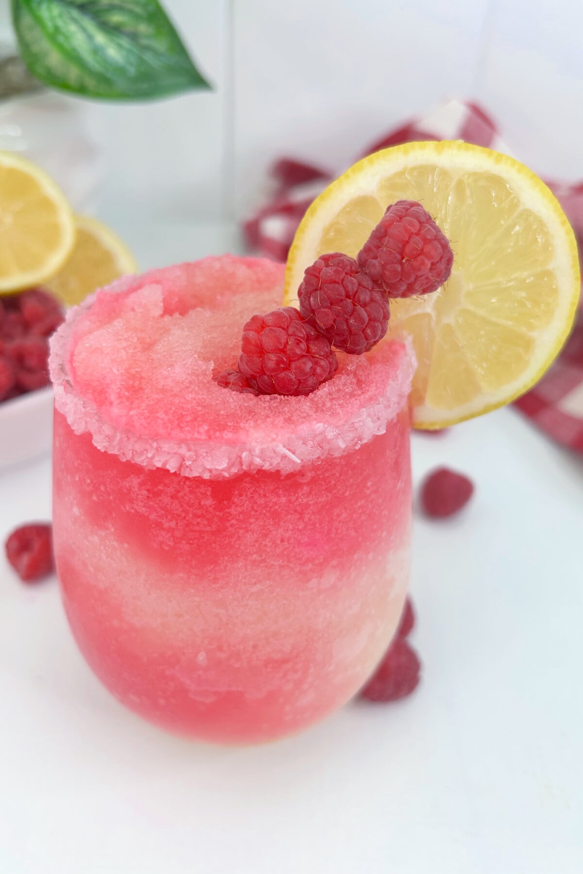 Raspberry Lemonade Cocktail on a white table.