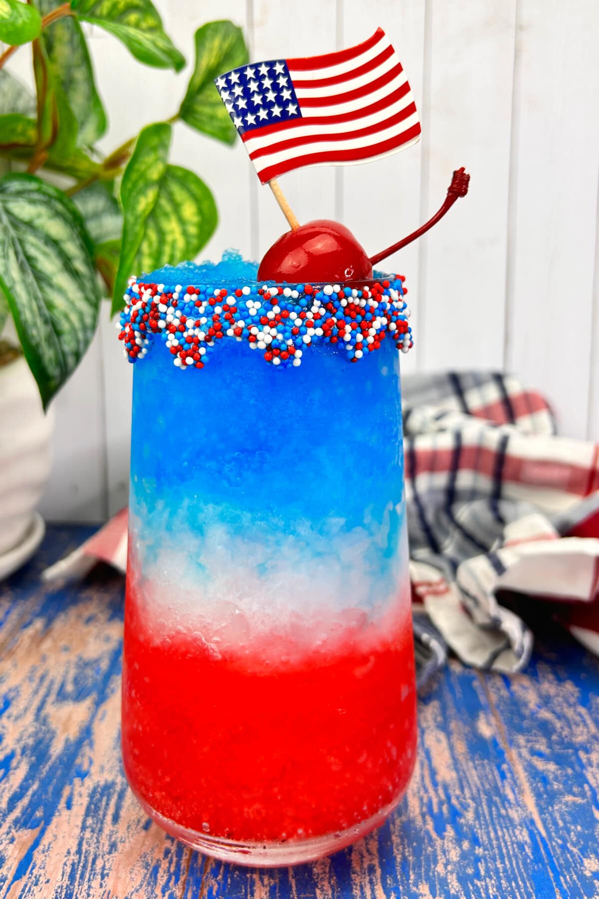Red White and Blue Margaritas on a blue wooden table.

