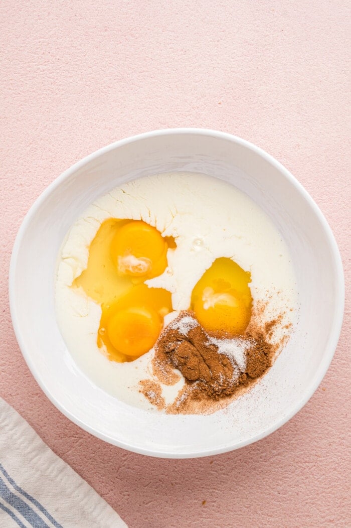 Milk, eggs, and cinnamon in a bowl