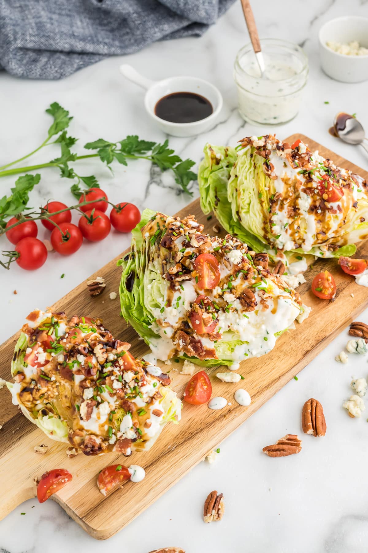Three wedge salads on a cutting board