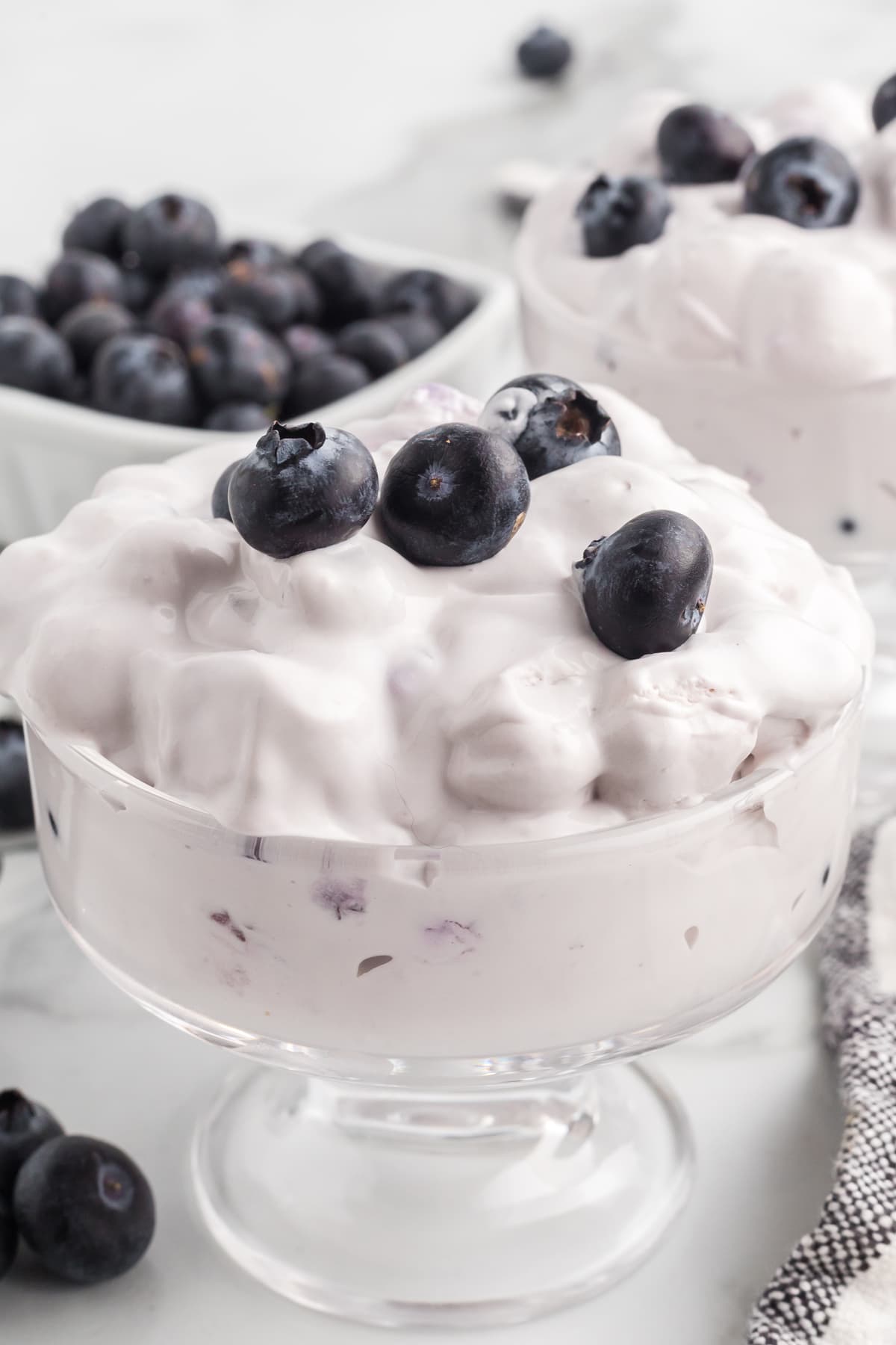 blueberry fluff in glass with fresh blueberries on top