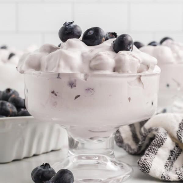 blueberry fluff salad in glass with fresh blueberries on top