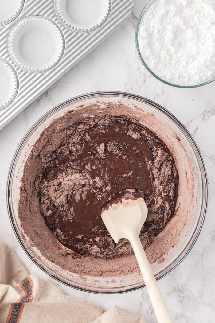 chocolate cupcake batter mixed in glass bowl