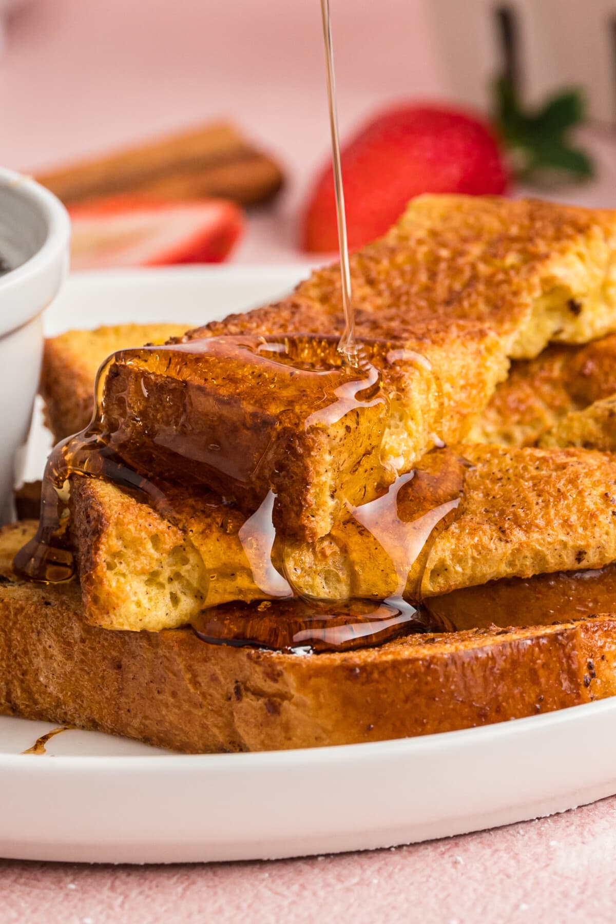 Air Fryer French Toast Sticks stacked on a plate