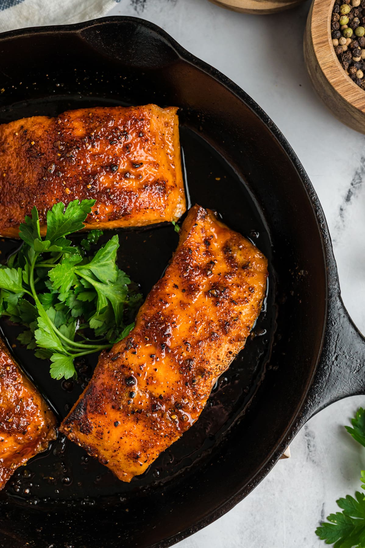 Overhead view of honey glazed salmon in a skillet