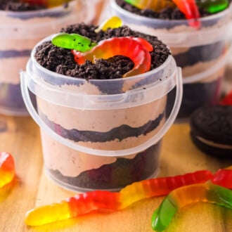 dirt pudding in plastic buckets with gummy worms on top