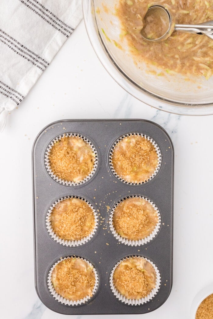 Zucchini muffins in a muffin pan ready to be baked