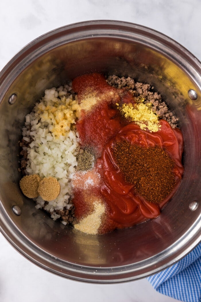 spices added to cooked ground beef for hot dog chili