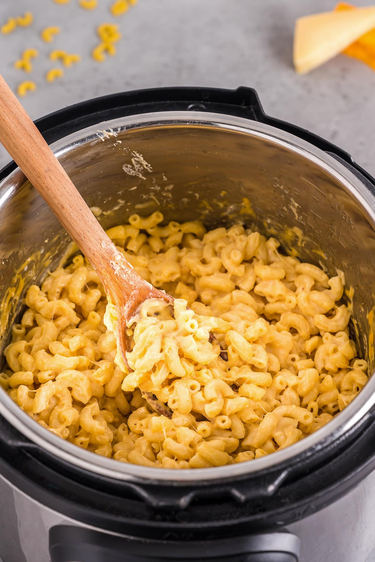 instant pot mac and cheese with wooden spoon serving