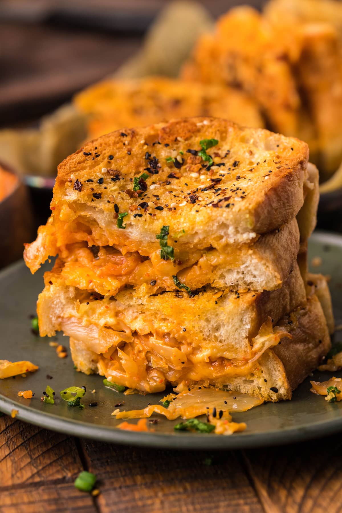 Two kimchi grilled cheese sandwiches cut in half and stacked on each other
