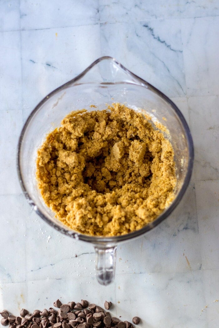 peanut butter bars mixed in glass mixing bowl