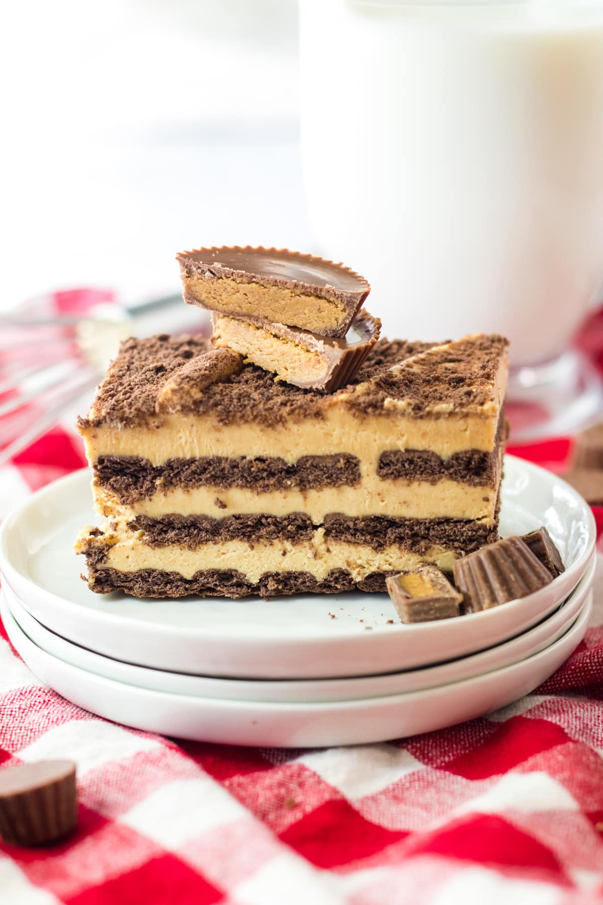 peanut butter icebox cake on white plate with peanut butter cups candy