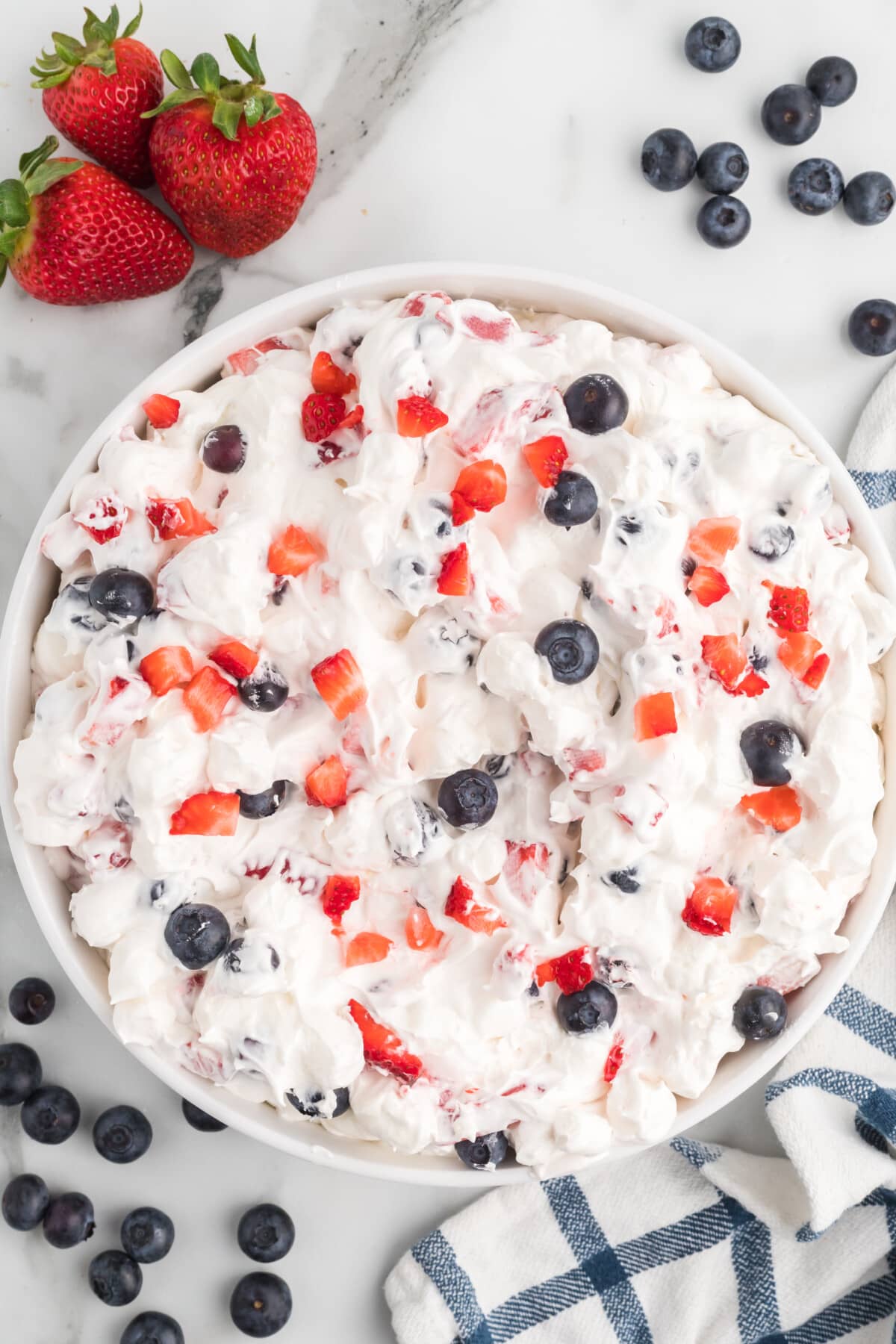 Red, white and Blue Cheesecake Salad in a clear bowl