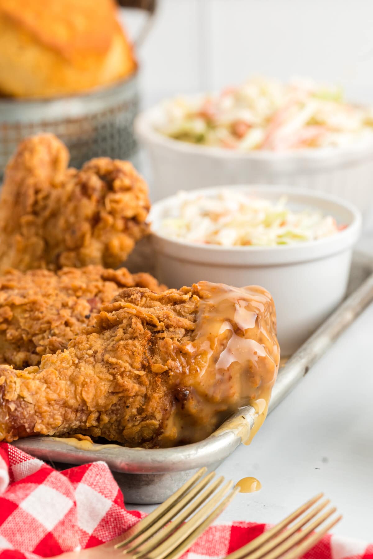 Fried Chicken on a tray with gravy on a drumstick