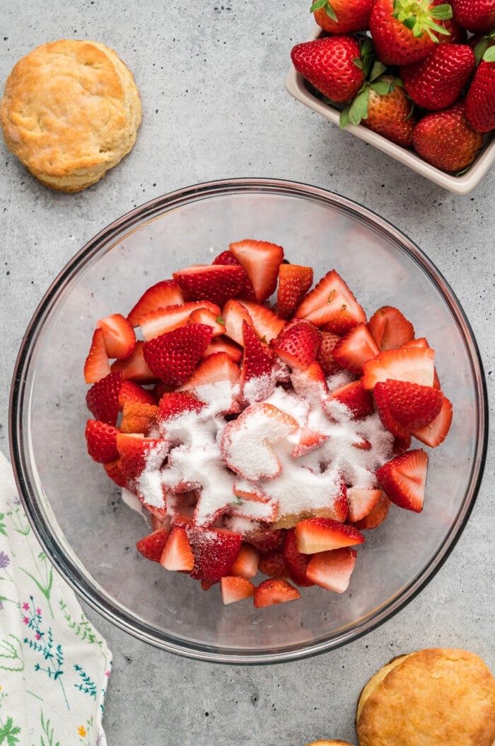 Quartered strawberries with sugar in a bowl