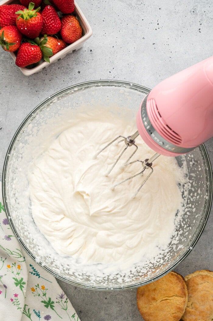 A mixer mixing homemade whipped cream