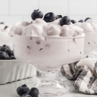 blueberry fluff salad in glass with fresh blueberries on top