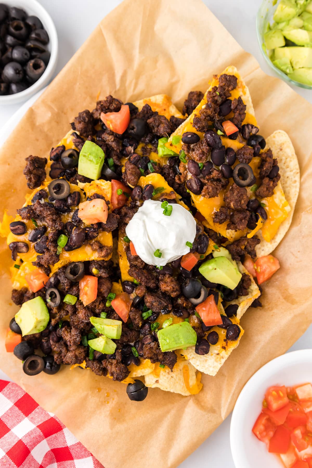 air fryer nachos with beans, tomatoes and sour cream