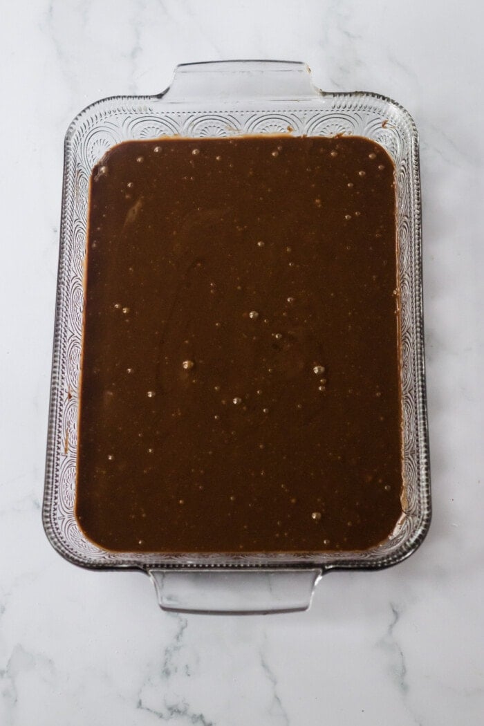 chocolate cake in glass baking dish ready for oven