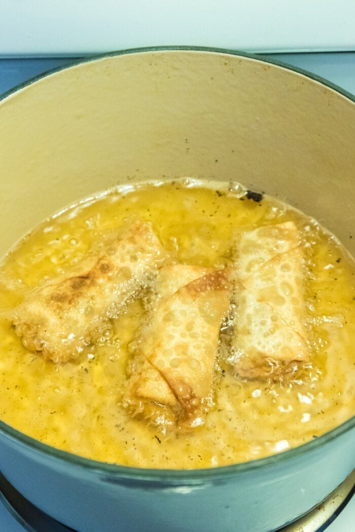 egg rolls cooking in oil
