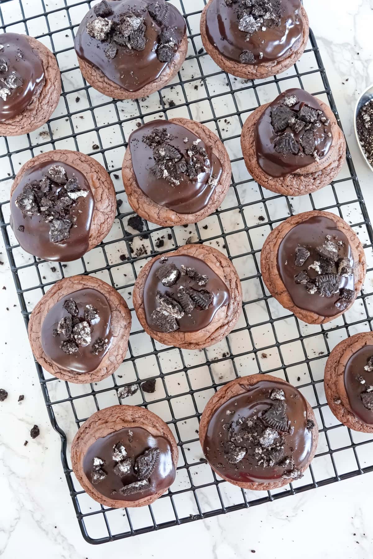 oreo stuffed cookies with chocolate glaze and oreo cookies crumbled on top