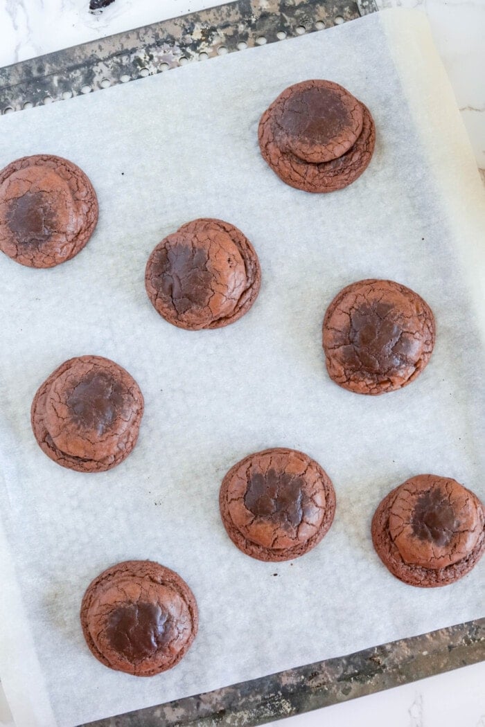 baked oreo stuffed cookies on parchment paper