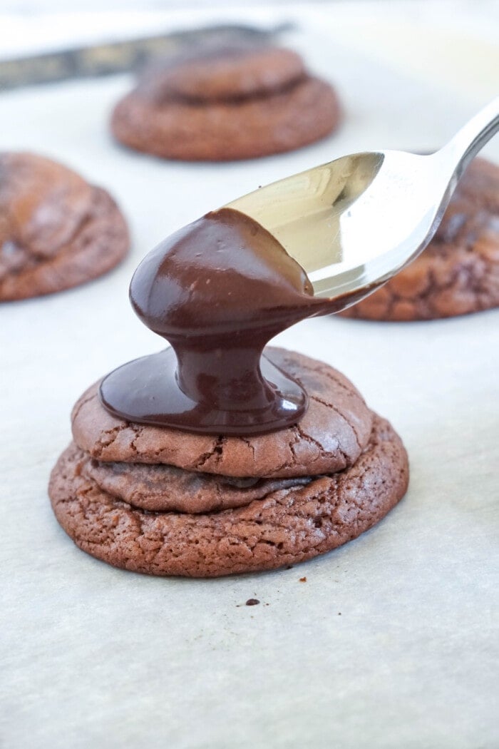 chocolate glaze spooned over oreo stuffed cookies