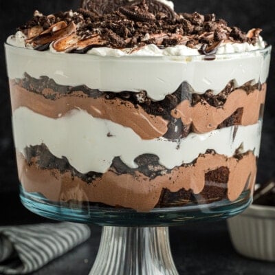 oreo trifle in glass dish with brownies, pudding and whip cream