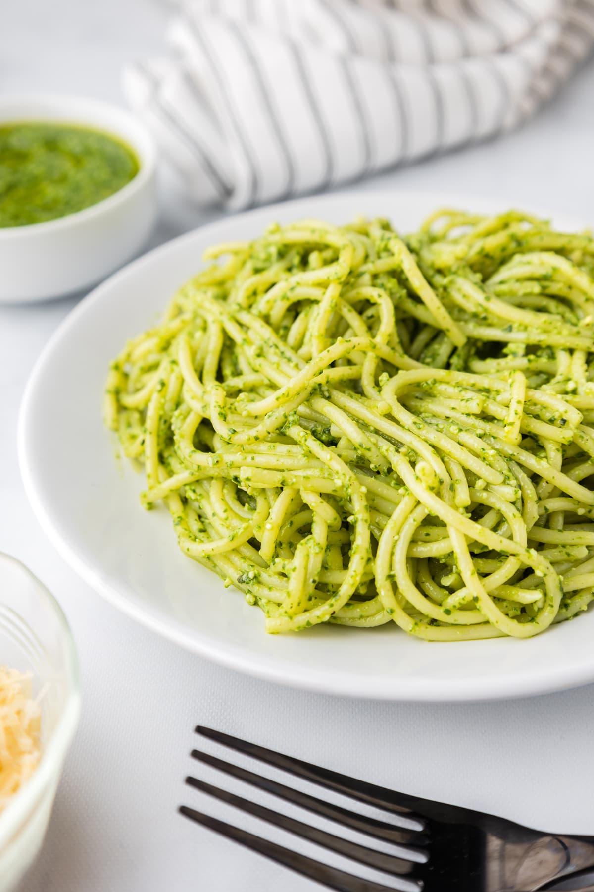 A plate of pasta with pesto sauce