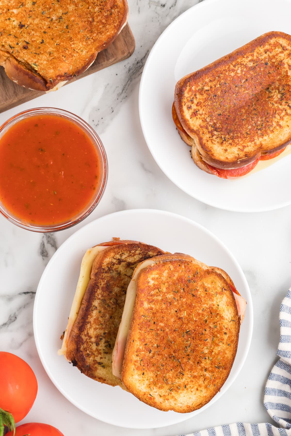 pizza grilled cheese sandwiches on white plates