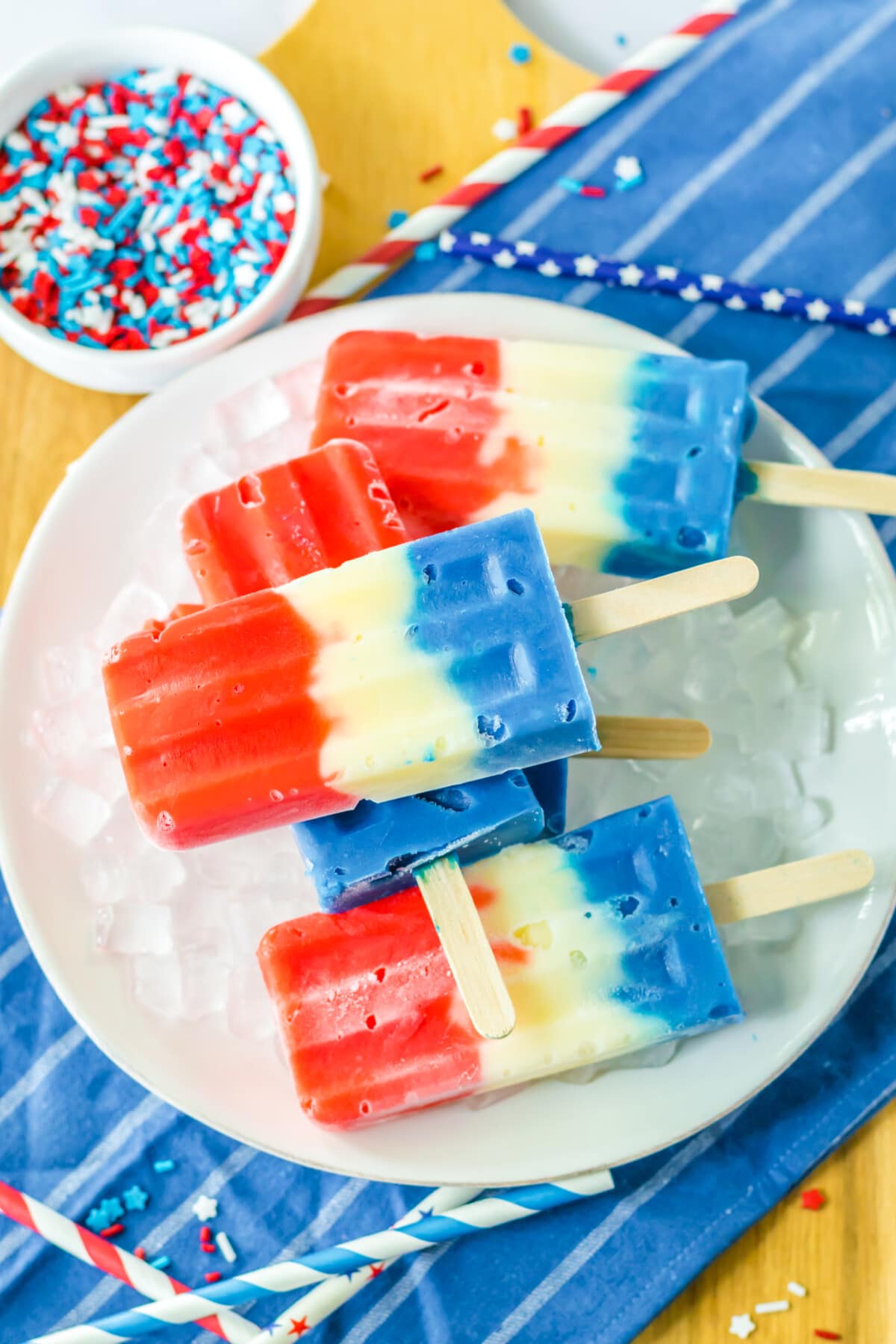 Red White and Blue Popsicles on a white plate and a blue napkin
