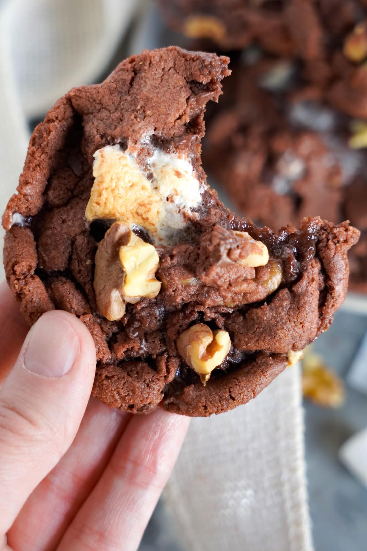 hand holding rocky road cookie with bite out