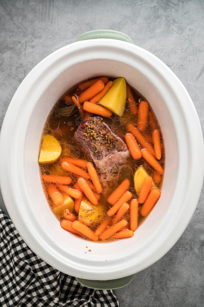 Corned beef, carrots, and potatoes in a slow cooker