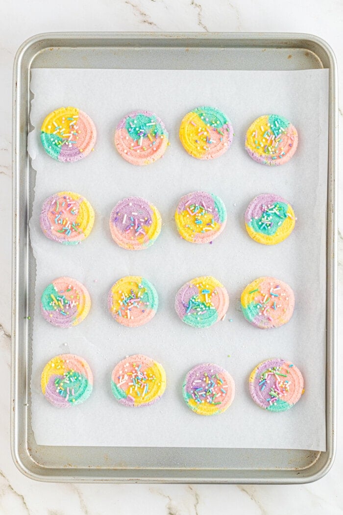unicorn cookies on baking sheet with sprinkles