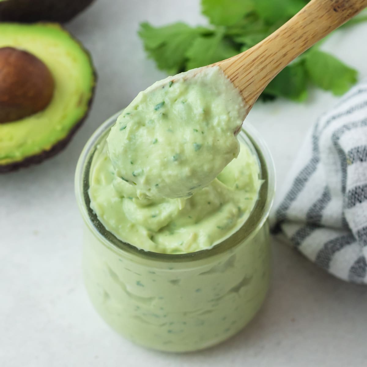 avocado crema on wooden spoon