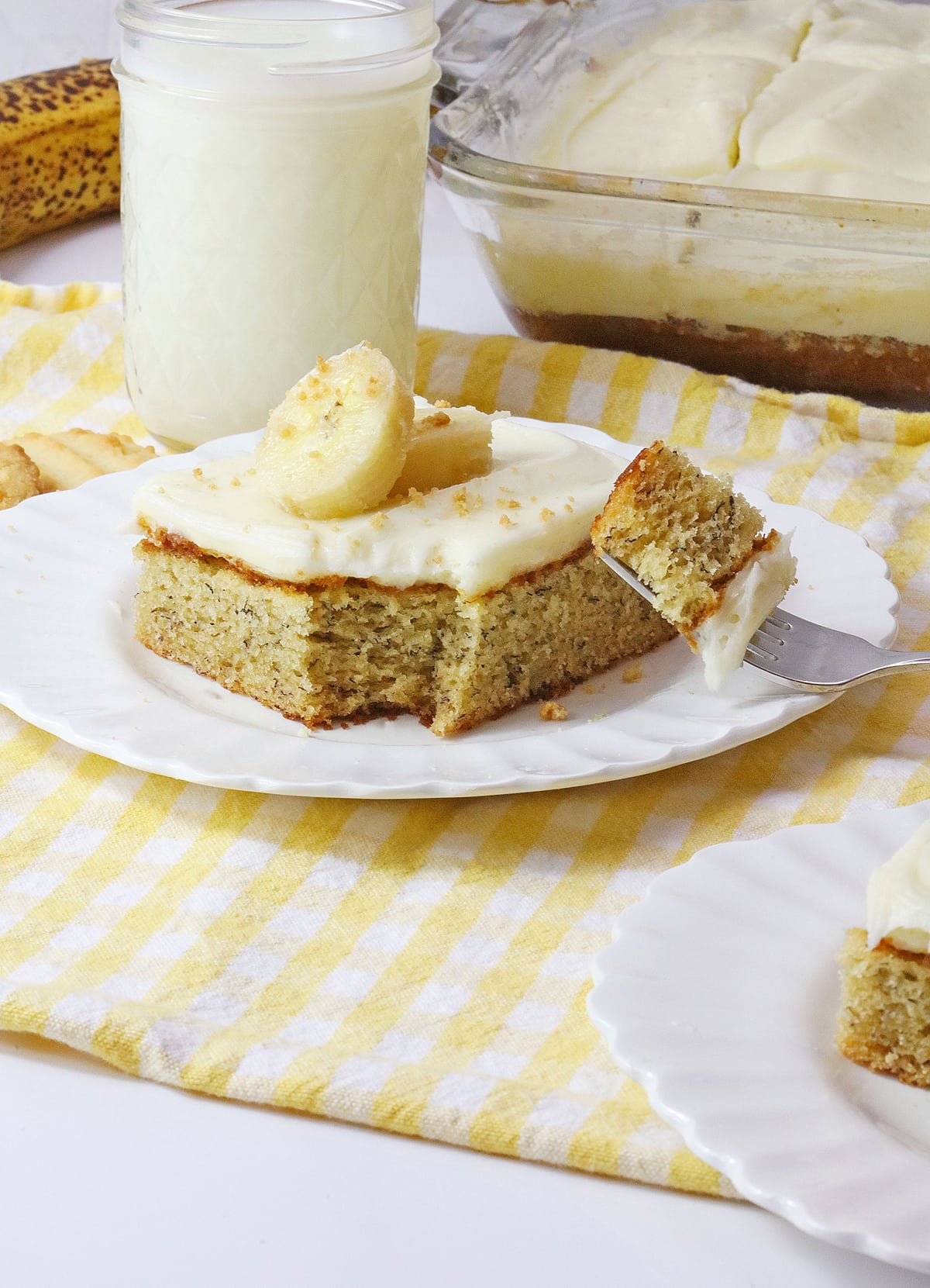 fork bite of banana bars with cream cheese frosting
