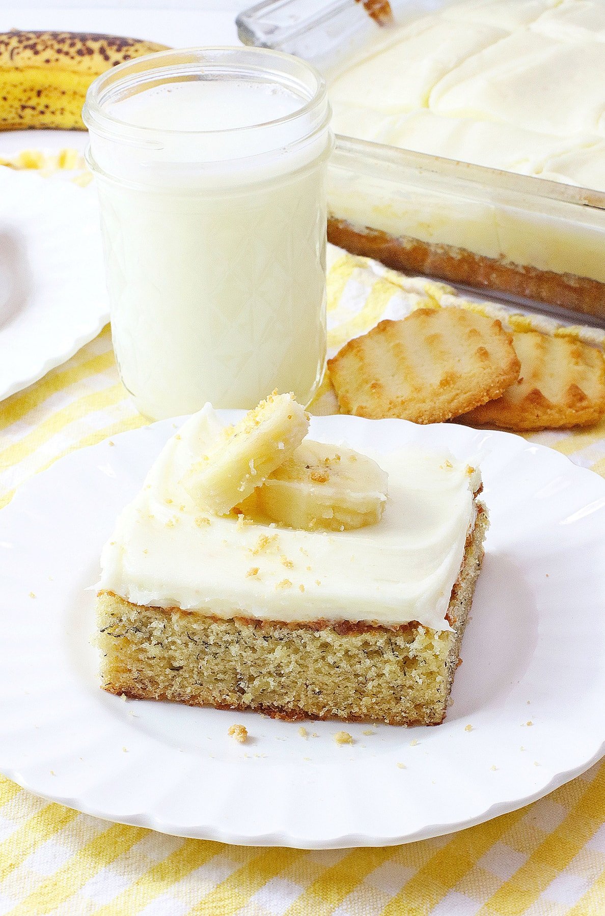 banana bars with cream cheese frosting on white plate