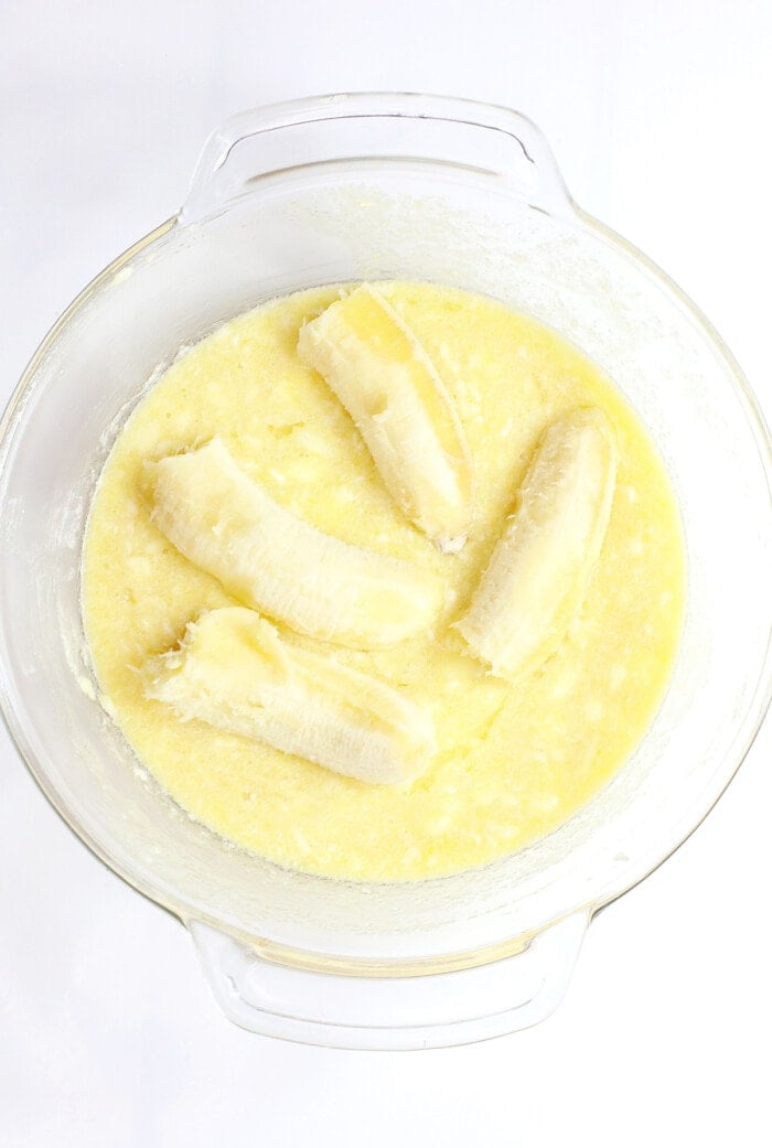 liquid ingredients in glass bowl with bananas