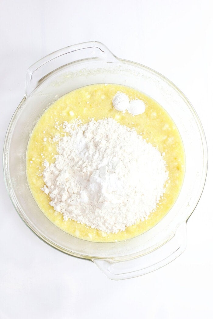 flour in glass bowl with liquid ingredients.