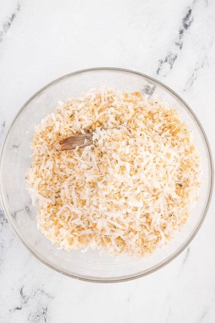 A shrimp in a bowl of coconut flakes