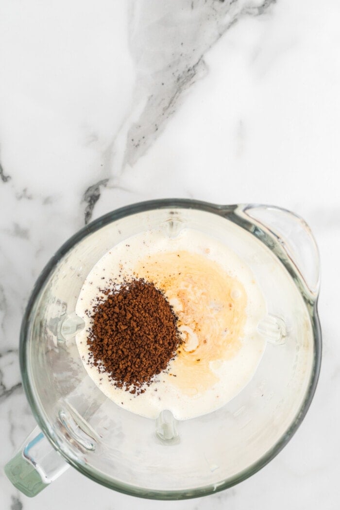 Heavy cream, sweetened condensed milk, and coffee granules in a blender