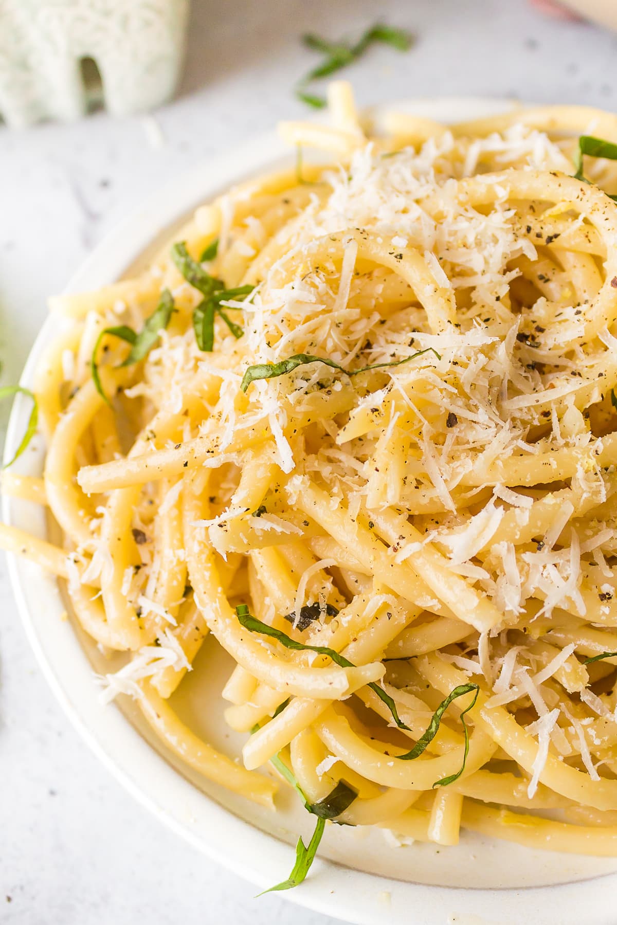 lemon garlic pasta served on plate with parmesan cheese