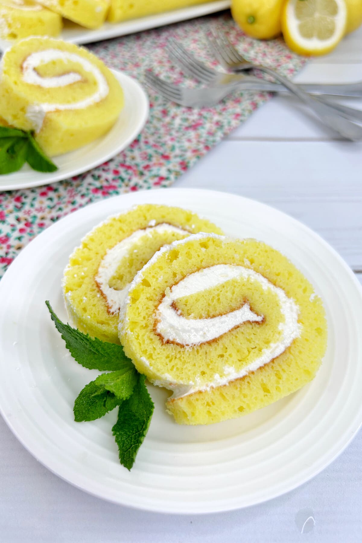 Lemon roll cake on a white plate