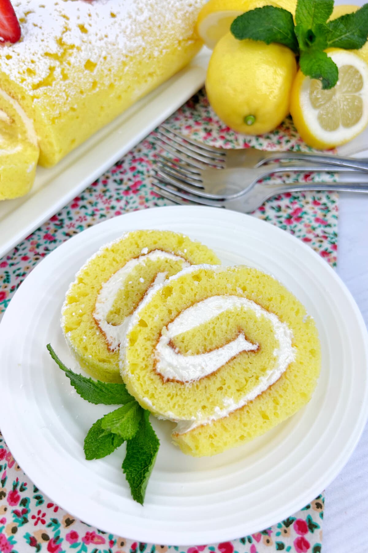 lemon roll cake on a white cake 